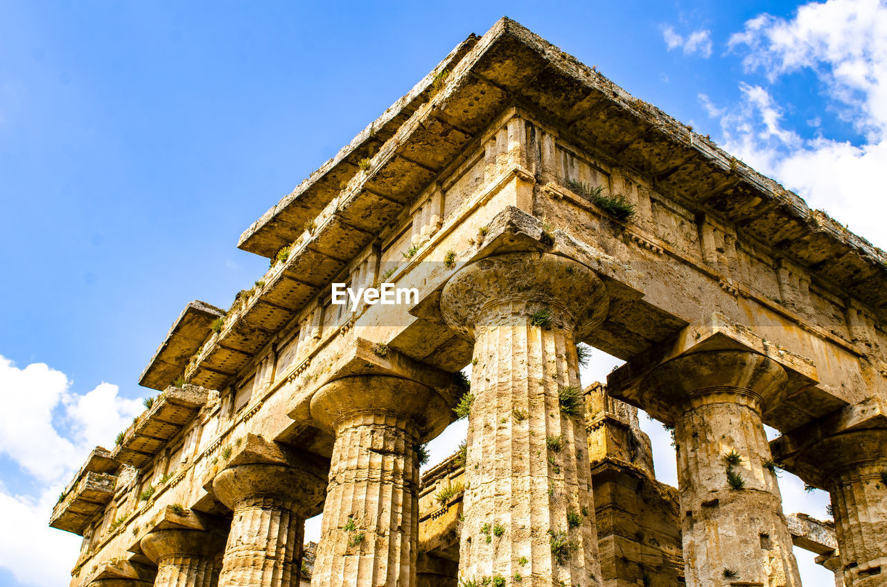 Detail view of historical building against clear blue sky  , temple of paestum. italy
