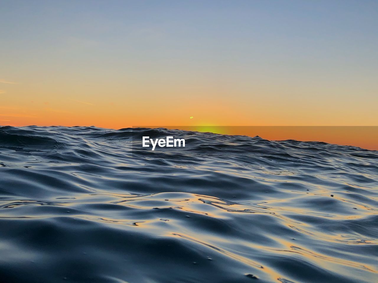 Scenic view of sea against clear sky during sunset