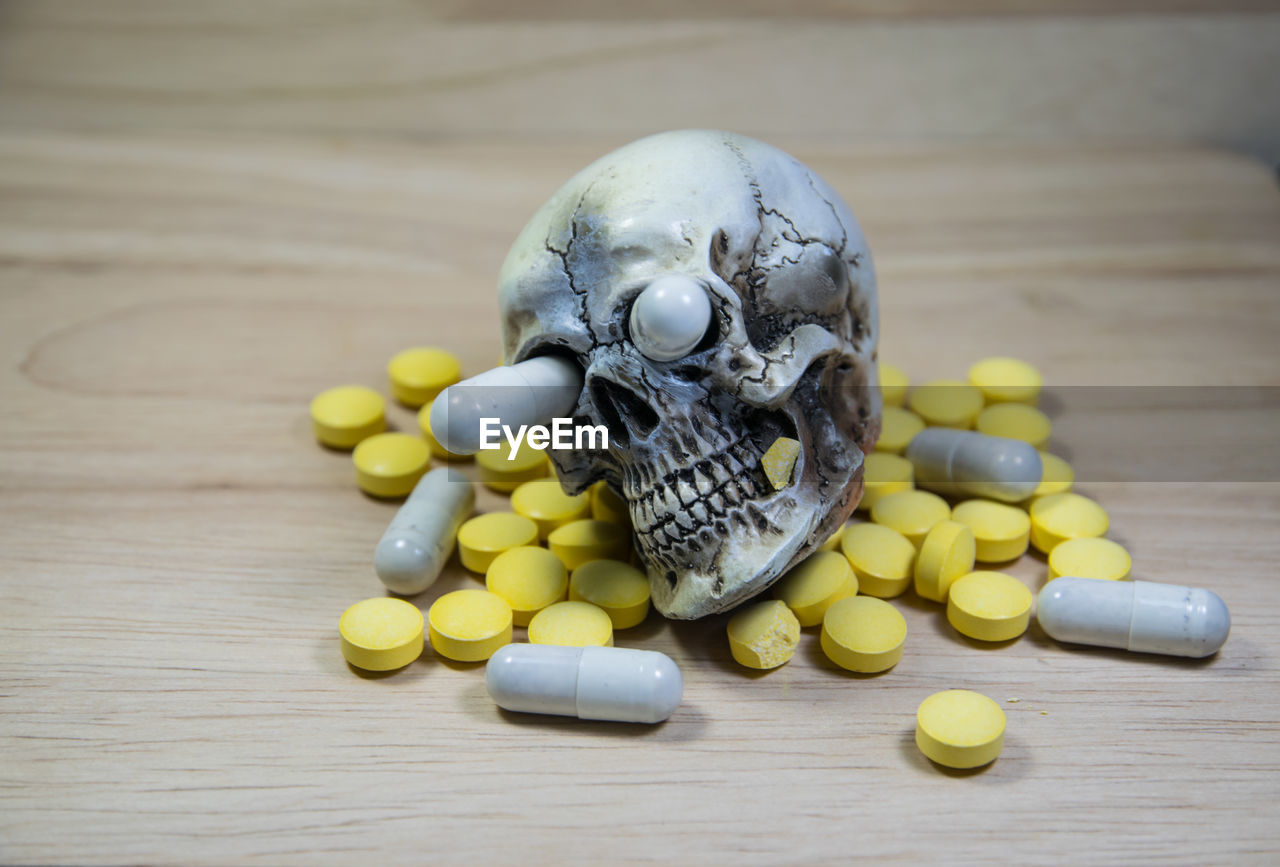 Close-up of medicines and skull on table