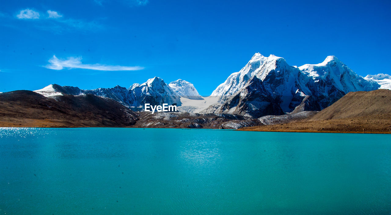 SCENIC VIEW OF SEA AND SNOWCAPPED MOUNTAINS AGAINST SKY