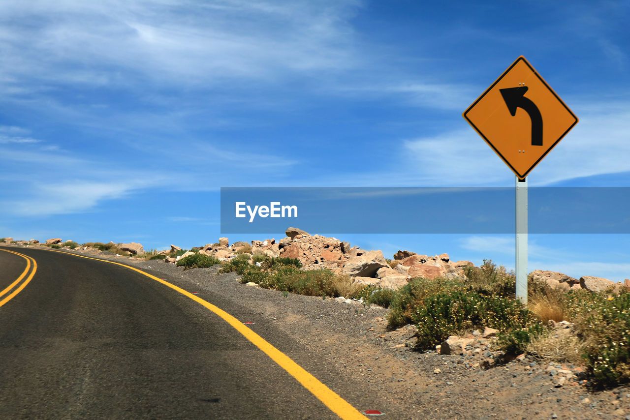 Road sign against sky