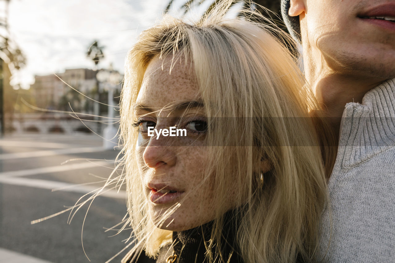 Freckle woman with boyfriend at promenade