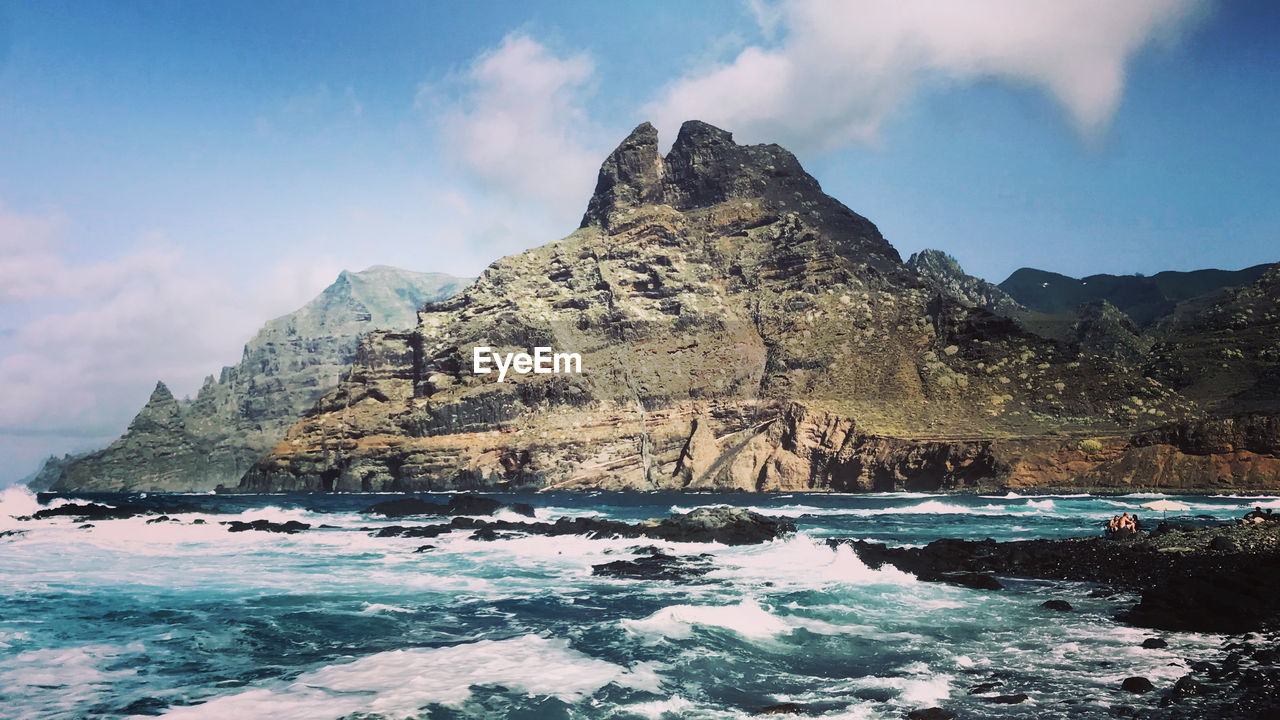 Scenic view of sea and rock formation against sky