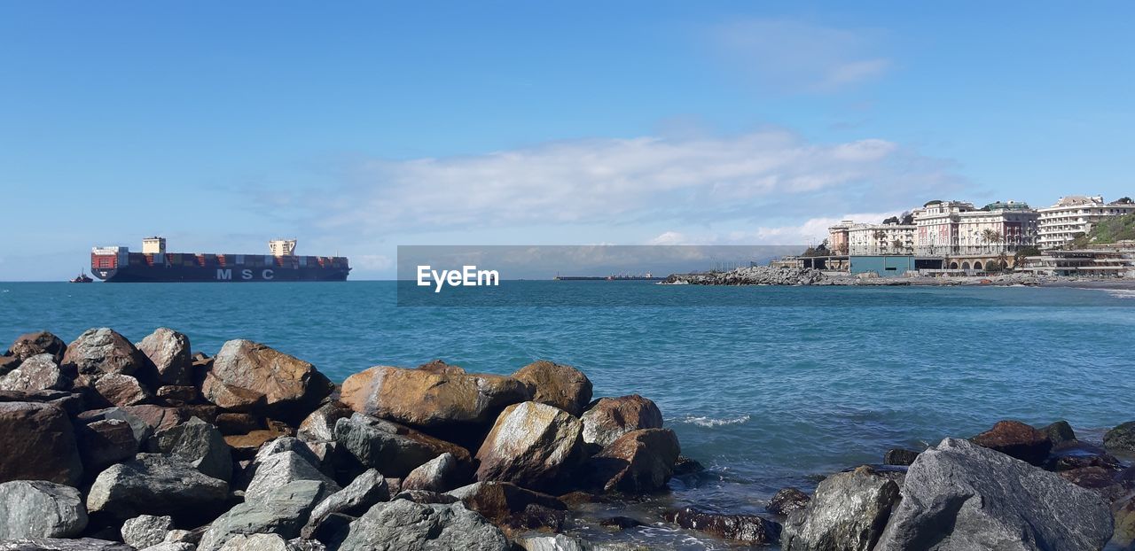 water, sea, ocean, shore, architecture, coast, sky, transportation, nautical vessel, vacation, rock, nature, body of water, beach, built structure, ship, building exterior, land, harbor, mode of transportation, building, bay, travel, cliff, travel destinations, city, cloud, blue, pier, day, terrain, business, no people, coastline, outdoors, shipping, horizon, commercial dock, industry, vehicle, freight transportation, scenics - nature, beauty in nature, wave, cove, tourism