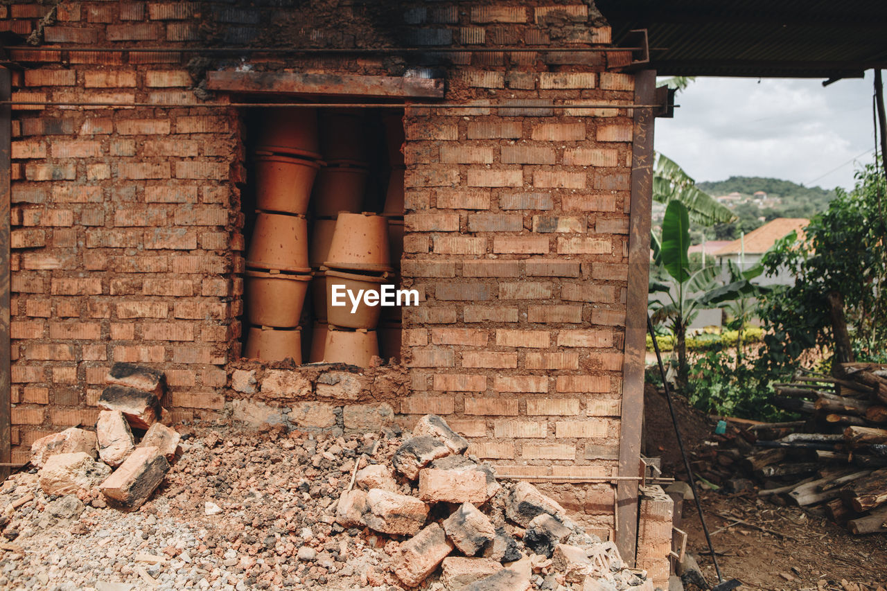 Clay pots in brick wall at warehouse