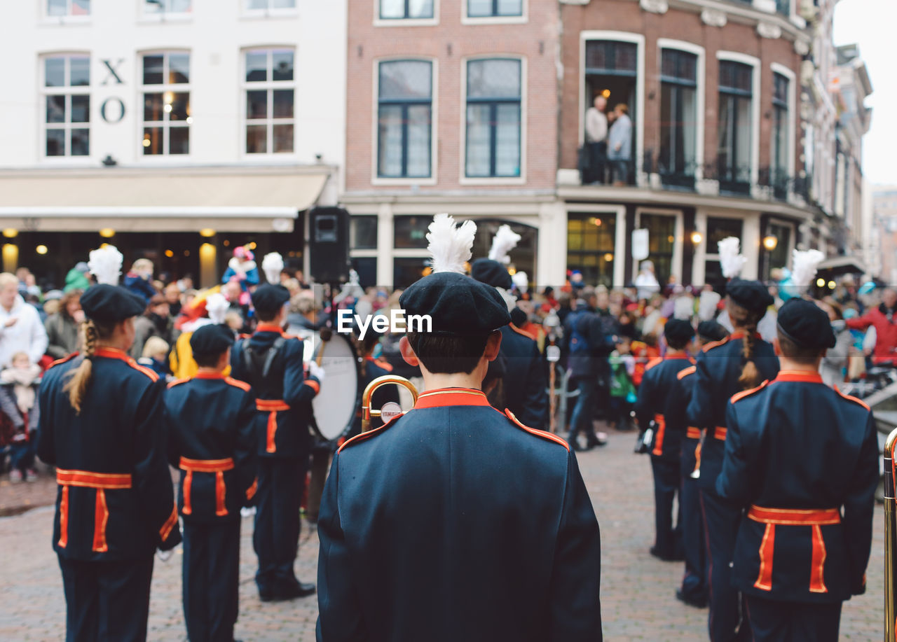 Rear view of marching band on street during festival