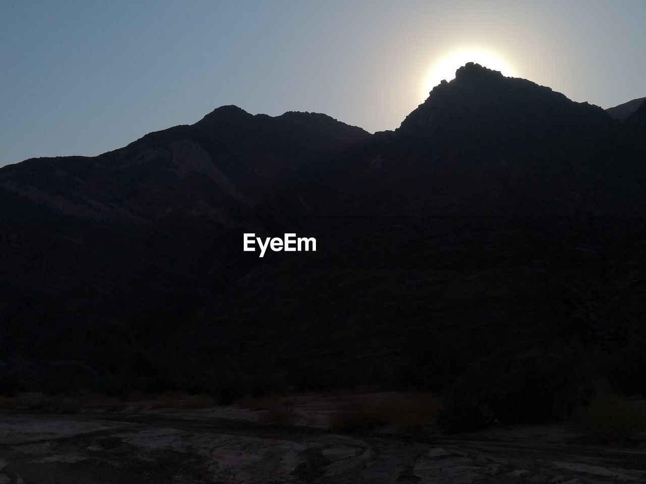 SCENIC VIEW OF MOUNTAINS AGAINST CLEAR SKY DURING SUNSET