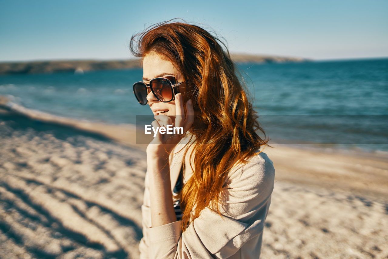 Young woman wearing sunglasses on beach