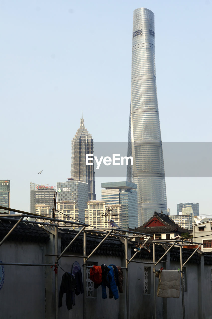 Low angle view of jin mao tower and shanghai tower against clear sky