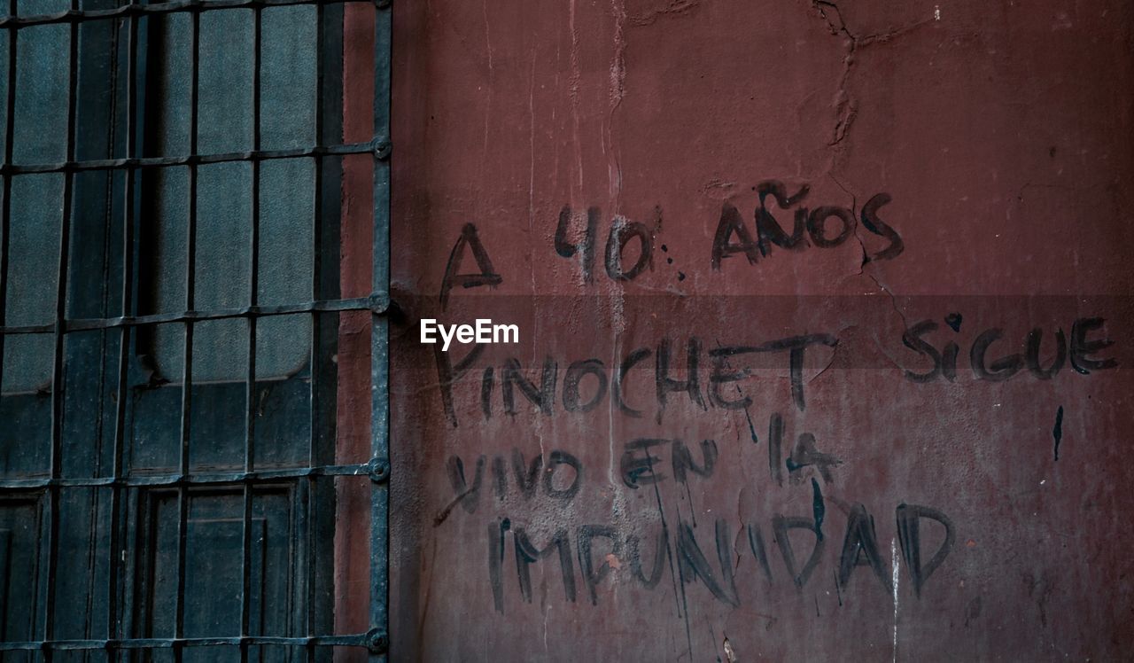 CLOSE-UP OF TEXT ON BRICK WALL