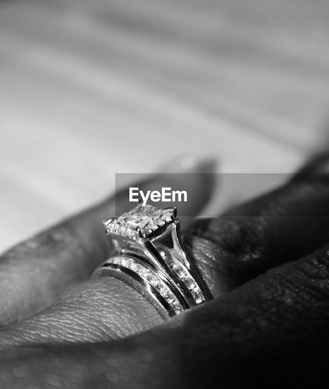 Cropped image of hand wearing shiny ring