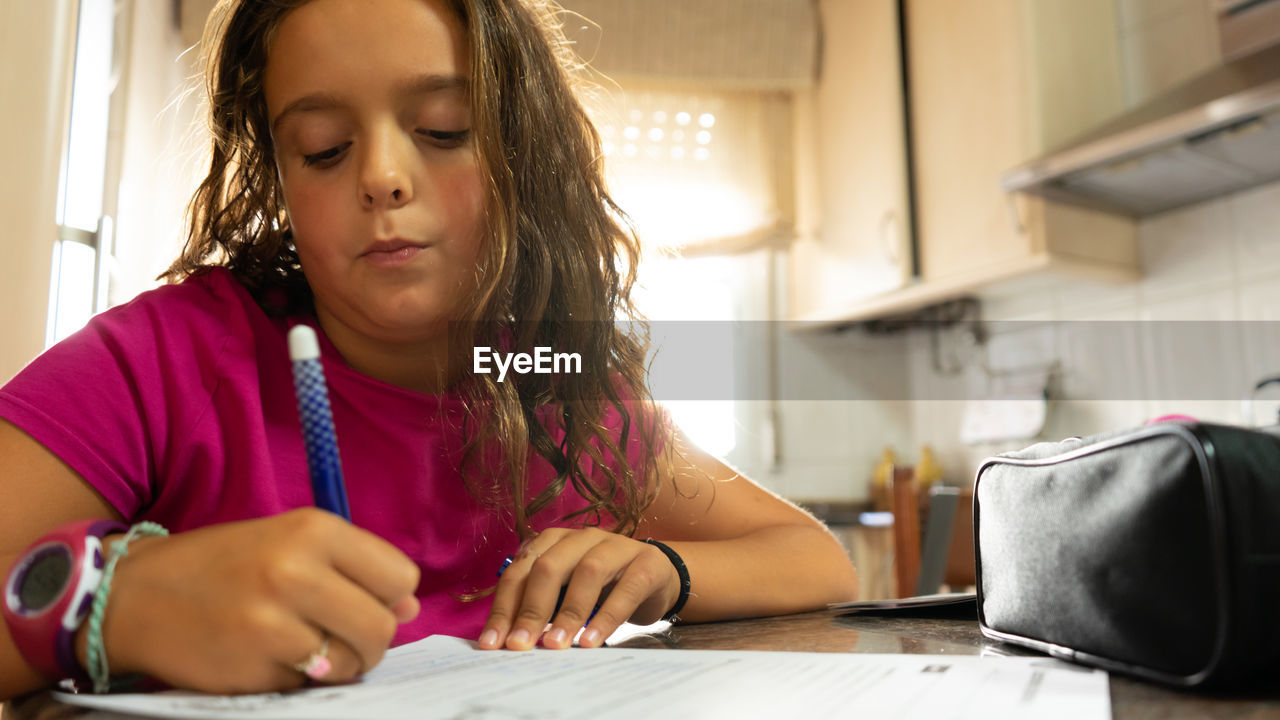 Girl writing on a piece of paper