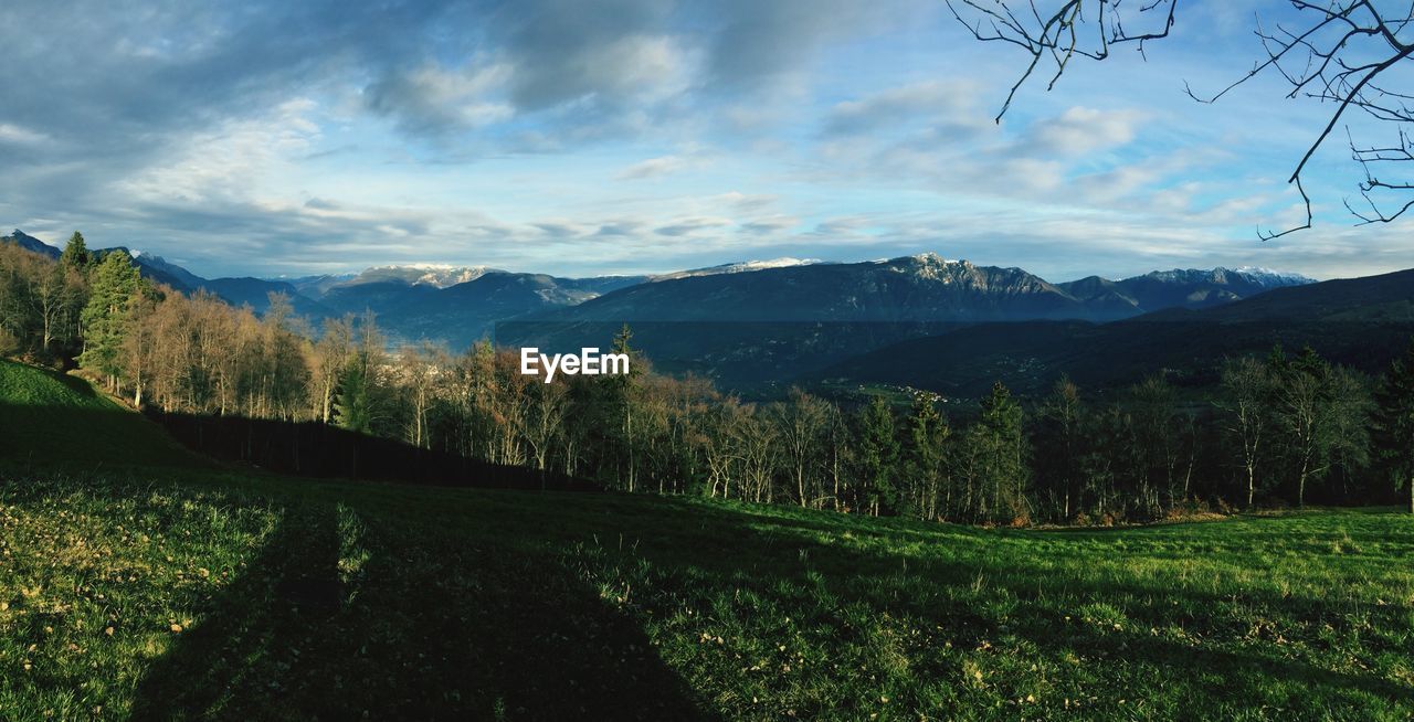 Scenic view of landscape against cloudy sky