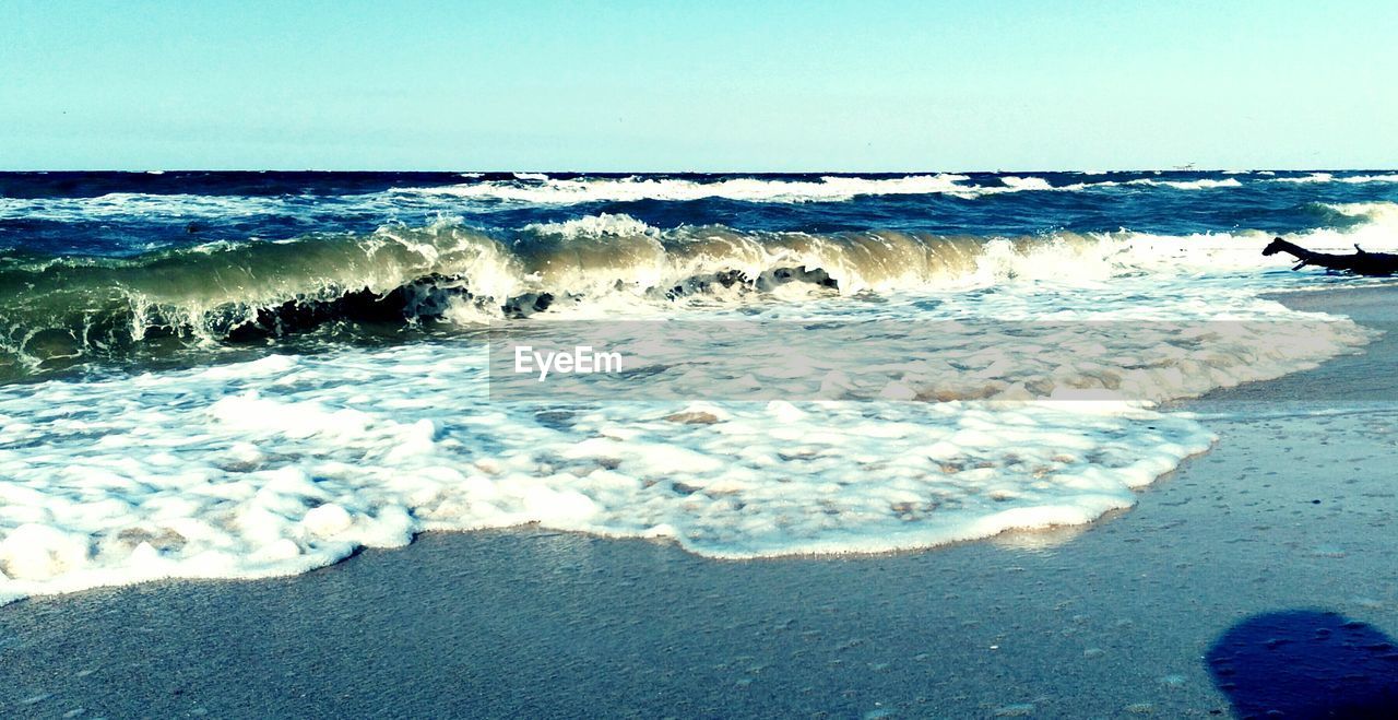 VIEW OF CALM BEACH AGAINST SKY