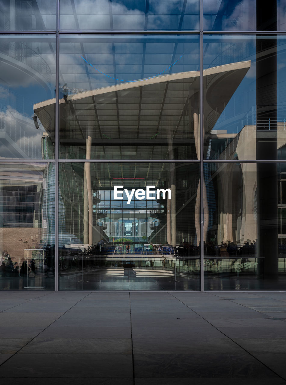 Reflection of building on glass in city