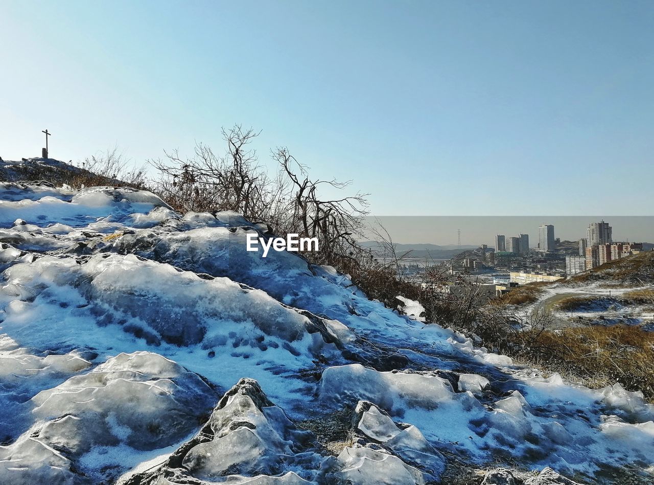 SNOW COVERED BUILDINGS AGAINST CLEAR SKY