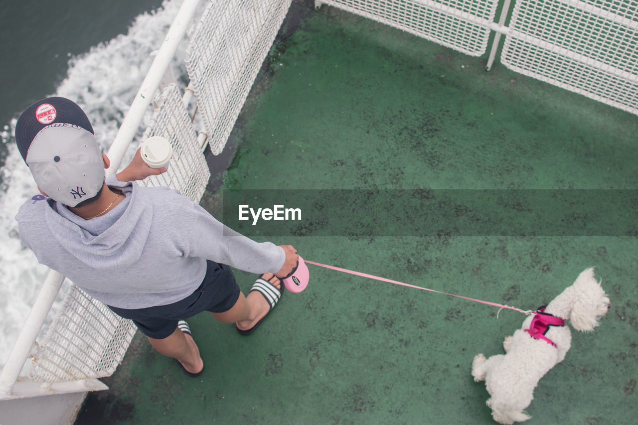 HIGH ANGLE VIEW OF BOY PLAYING WITH BALL