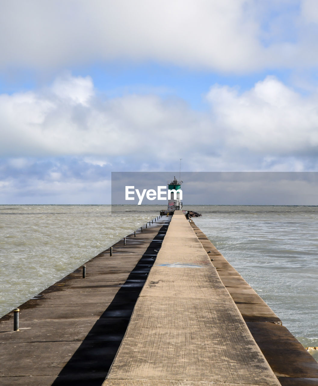 Pier over sea against sky