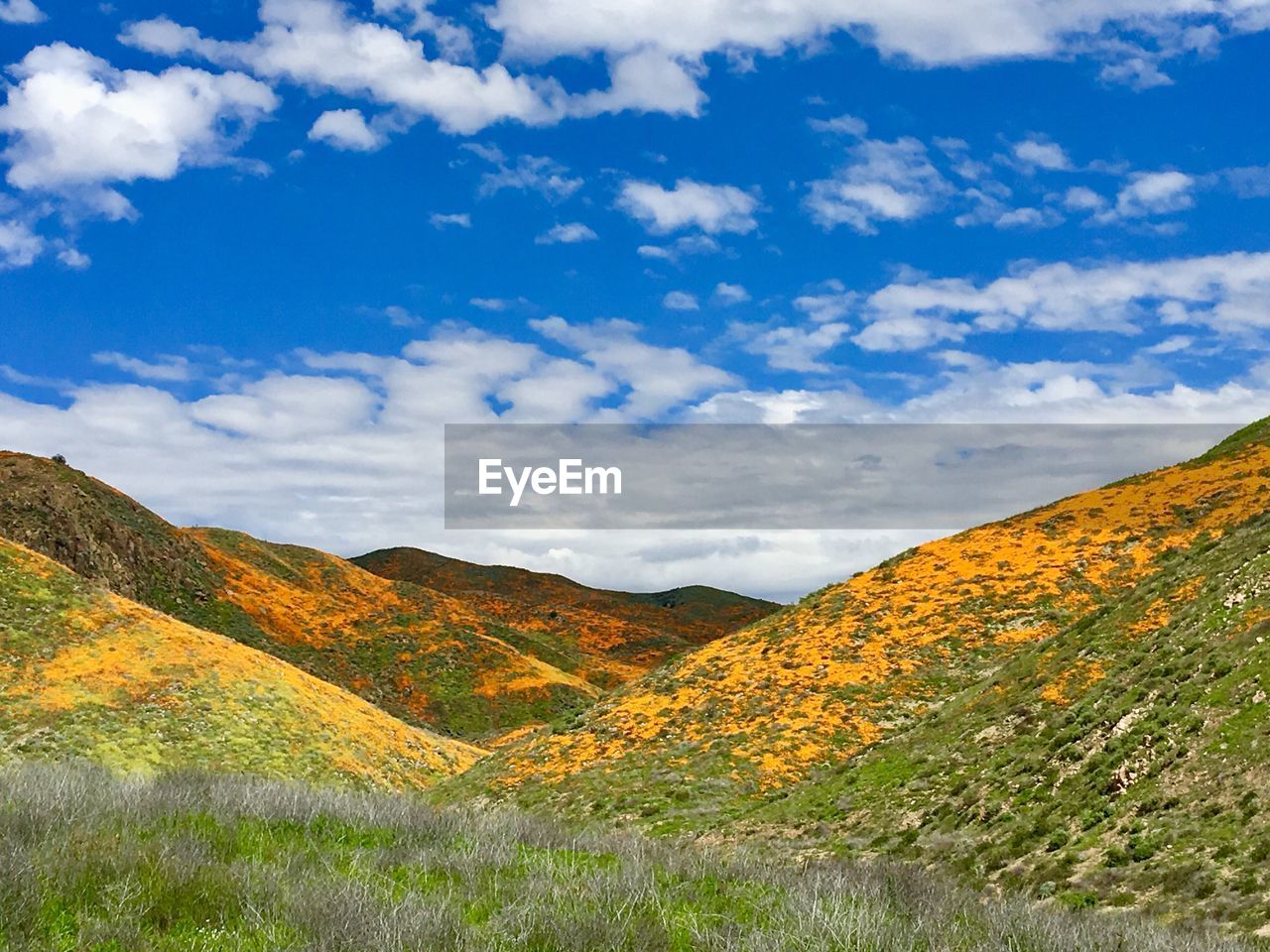 Scenic view of mountains against blue sky