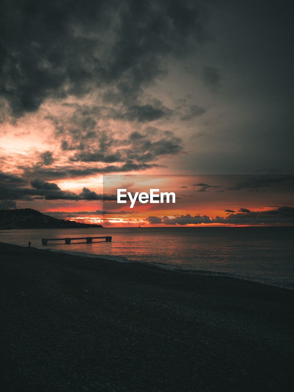 Scenic view of beach against sky during sunset