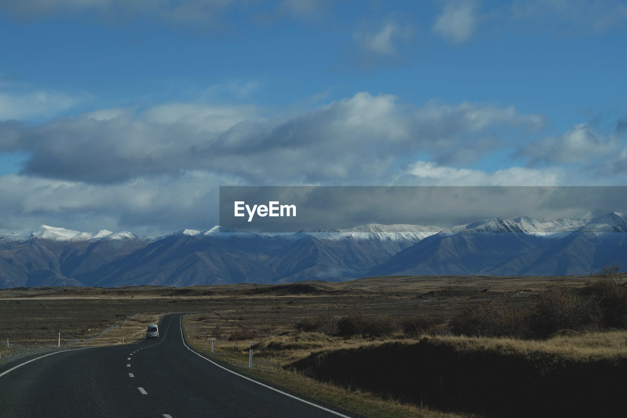 Scenic view of mountains against cloudy sky