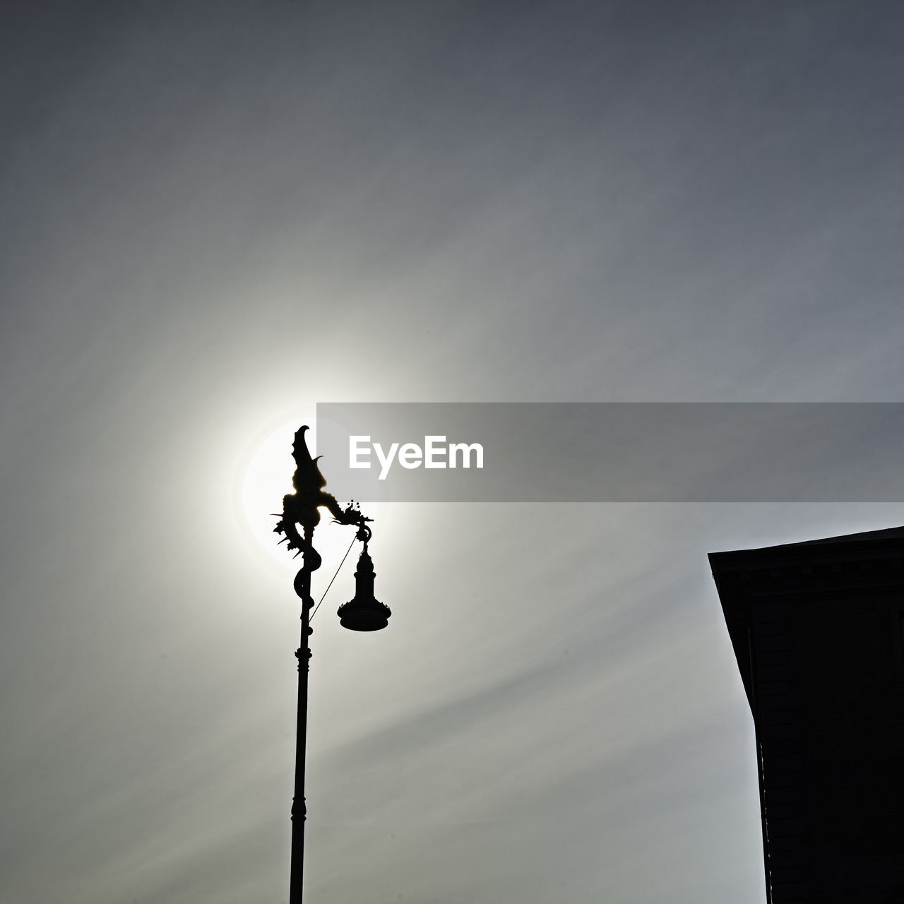 LOW ANGLE VIEW OF ILLUMINATED STREET LIGHT AGAINST SKY