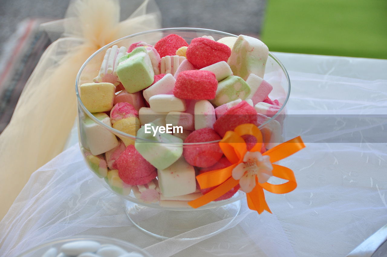 Close-up of colorful candies in glass bowl on table