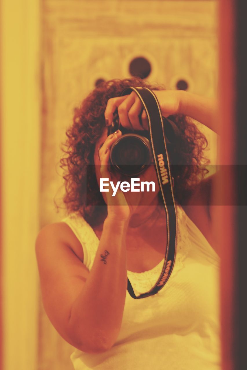 CLOSE-UP OF WOMAN HOLDING EYEGLASSES ON HAND