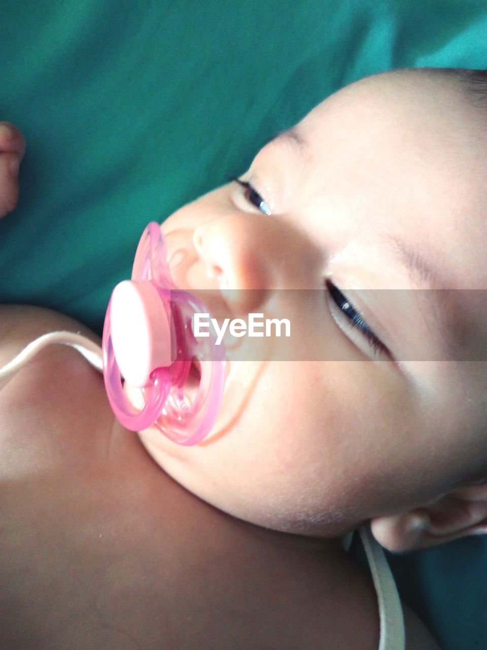 CLOSE-UP OF CUTE BABY GIRL IN BLANKET