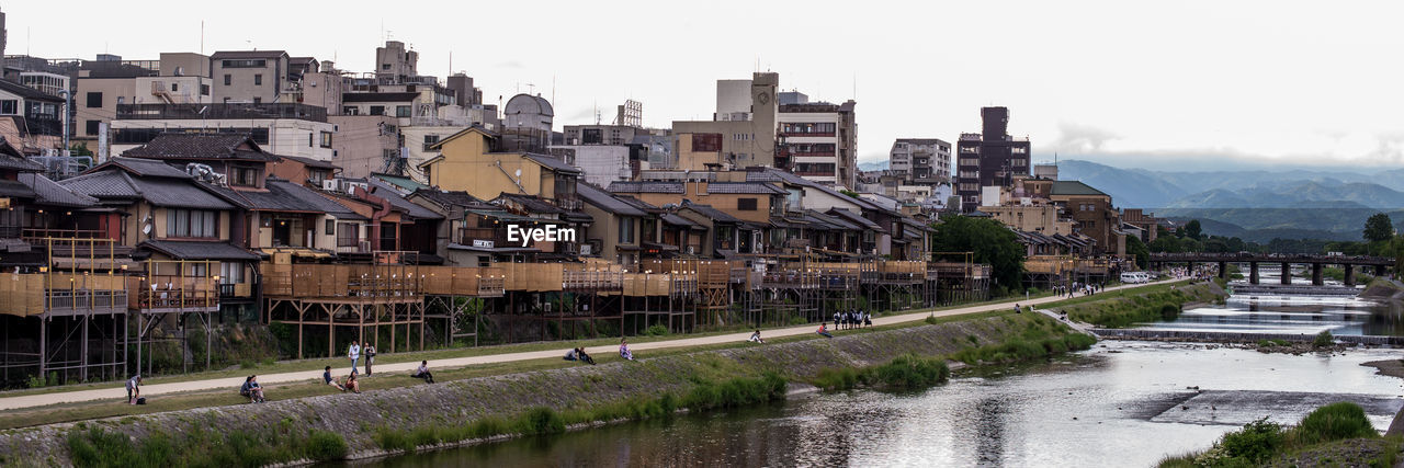 RIVER AMIDST BUILDINGS IN CITY