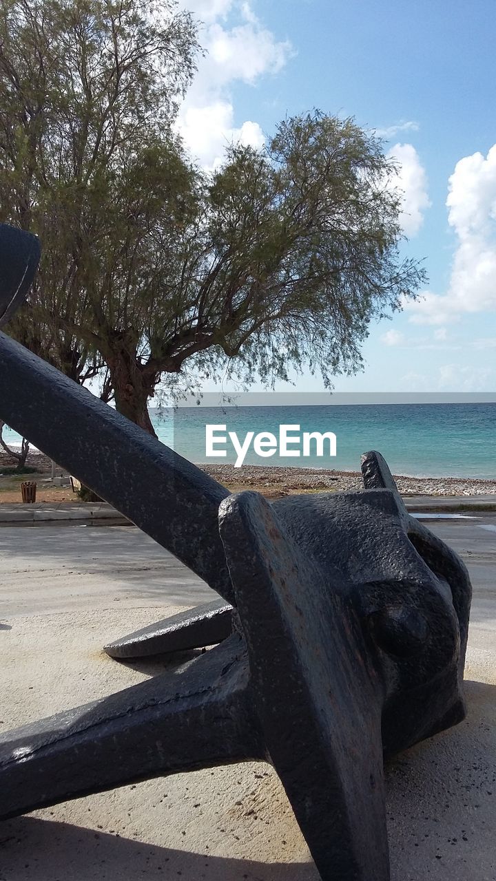 Anchor at beach on sunny day