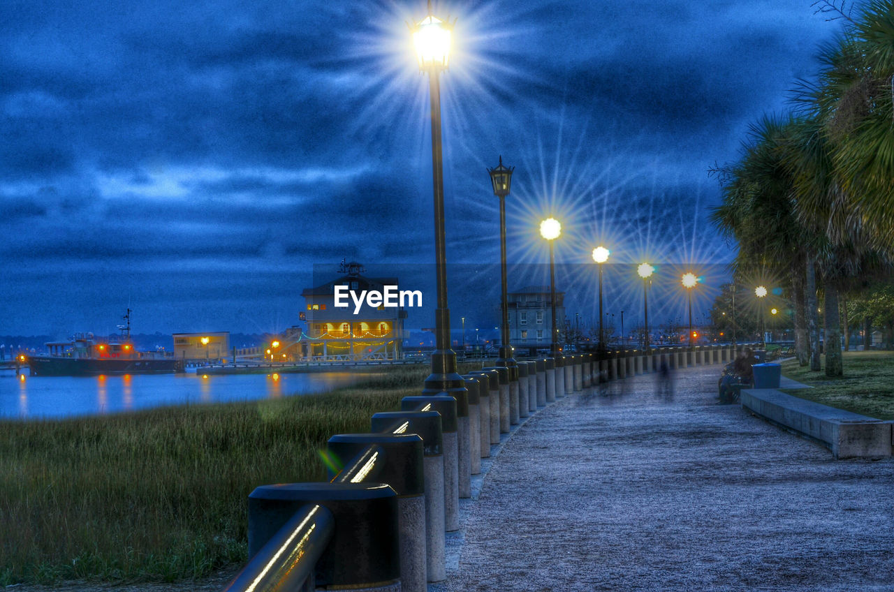 VIEW OF ILLUMINATED STREET LIGHT AGAINST SKY AT NIGHT