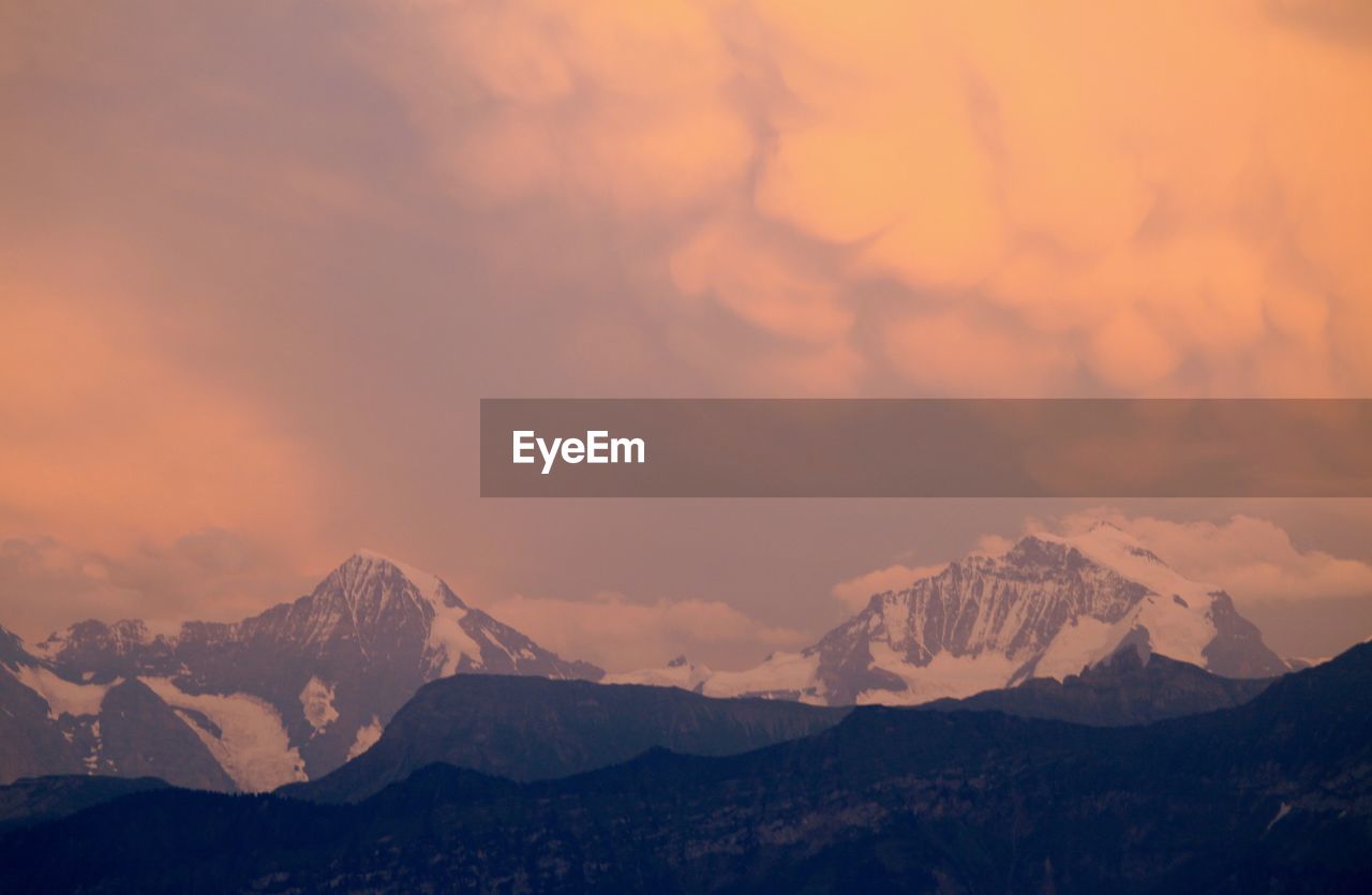 Scenic view of mountains against sky during sunset