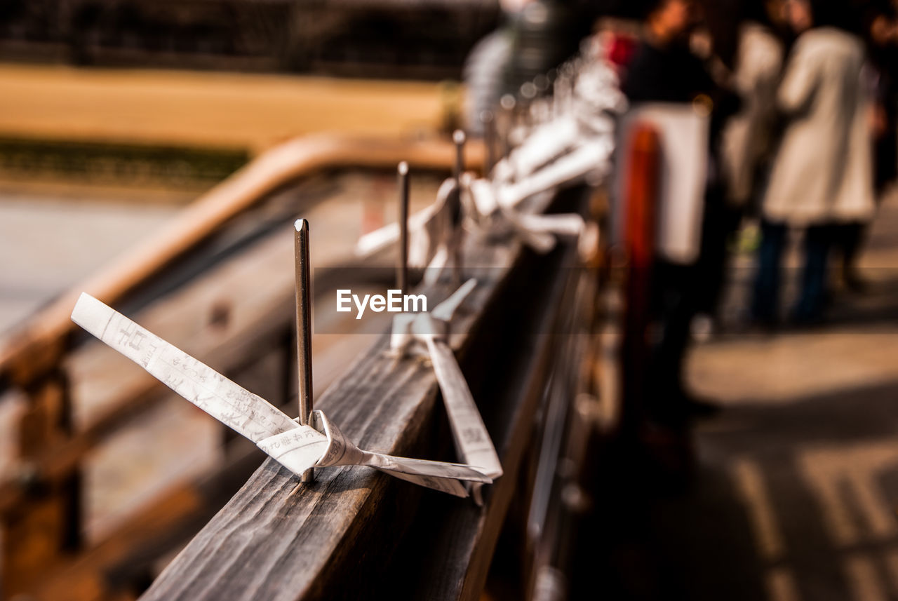 Close-up of paper on railing