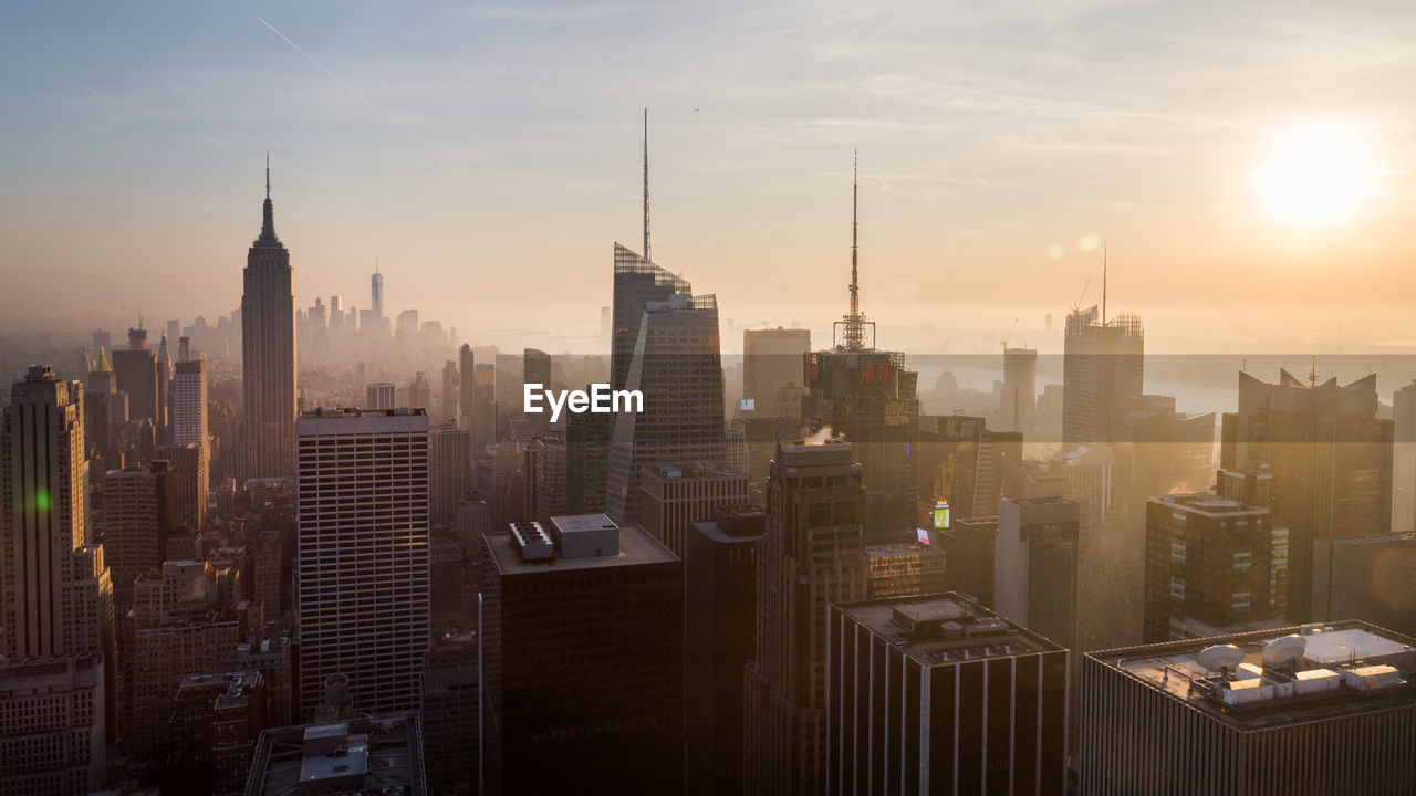 Silhouette of cityscape during sunset