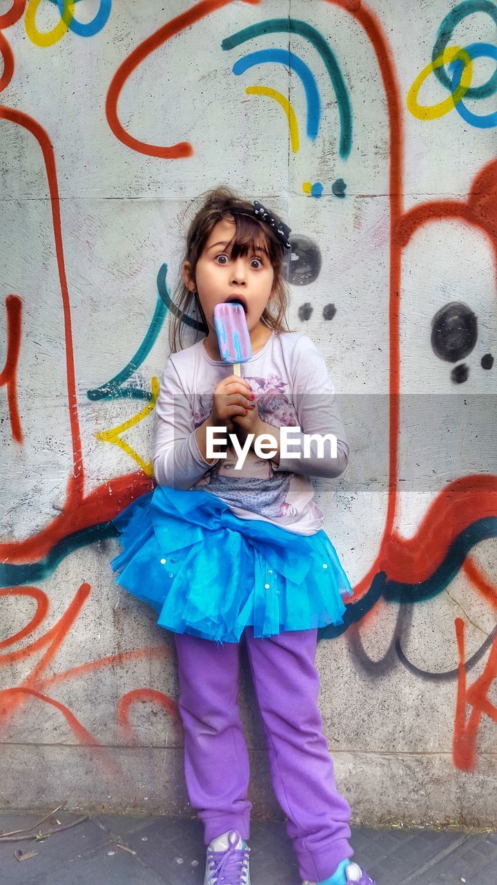 FULL LENGTH PORTRAIT OF GIRL HOLDING UMBRELLA