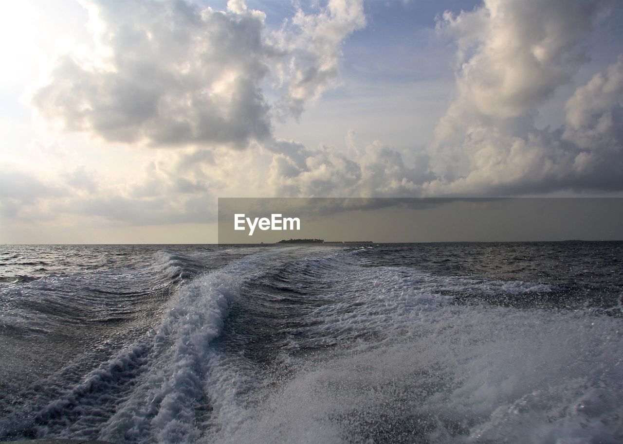 Scenic view of sea against cloudy sky