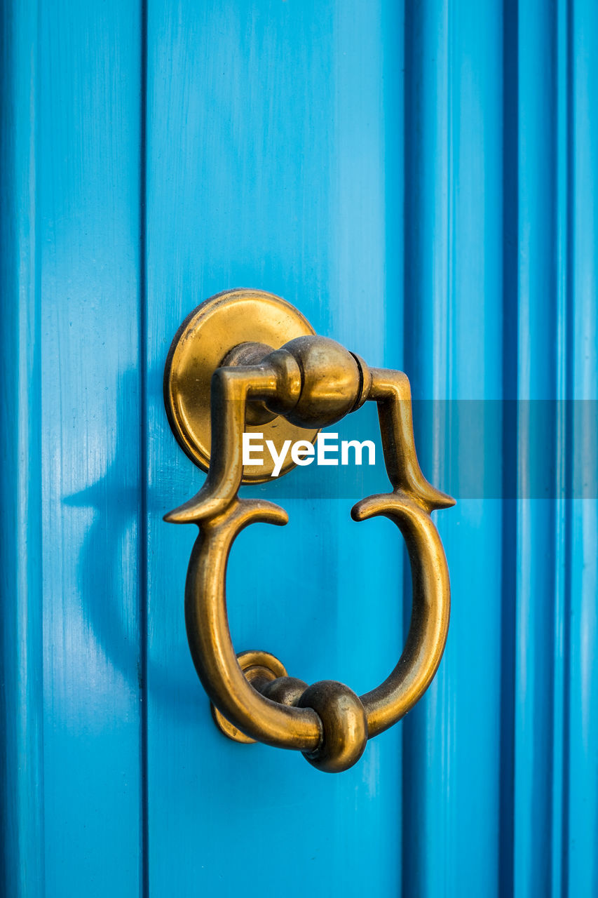 Close-up of blue door knocker