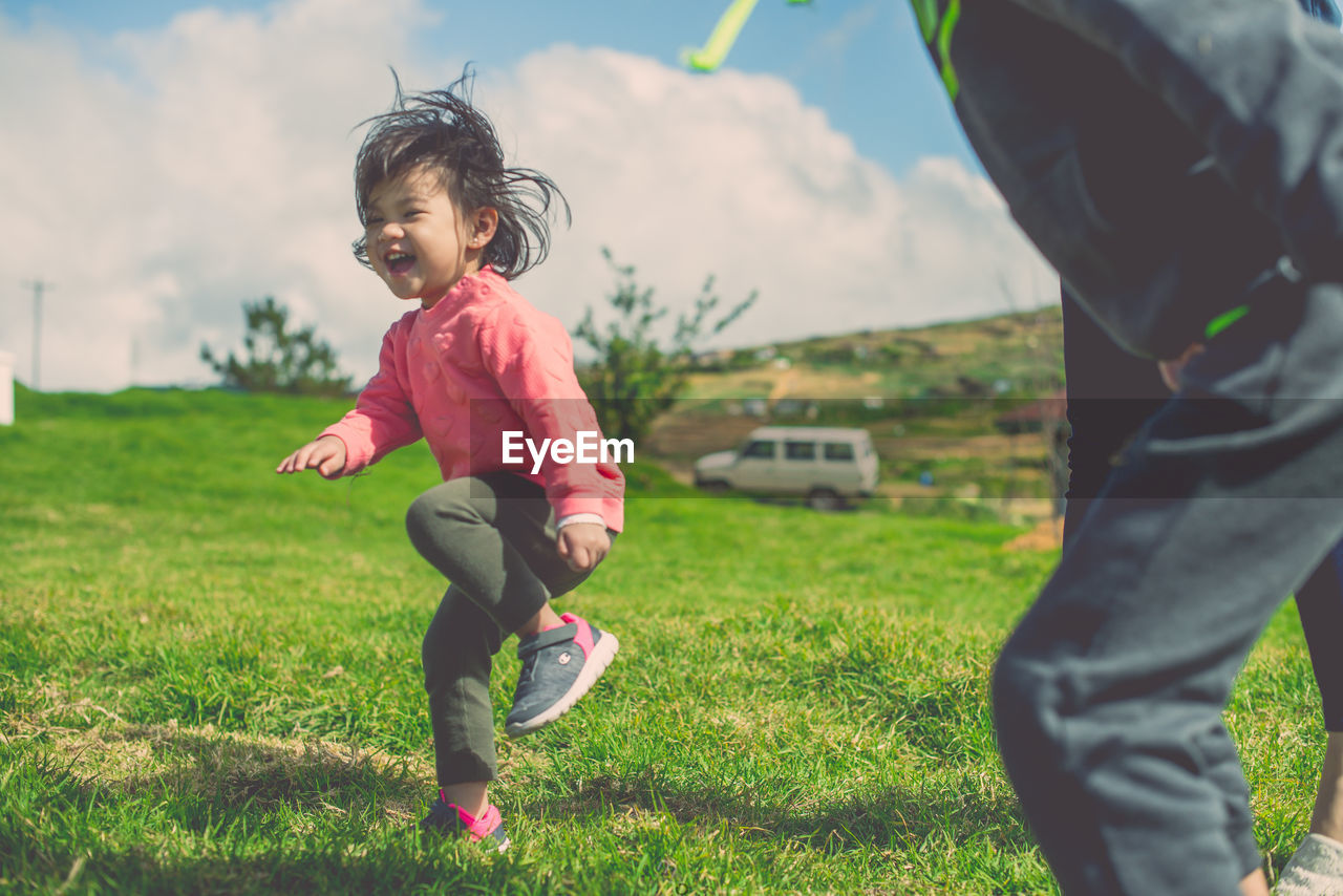 GIRL PLAYING ON FIELD