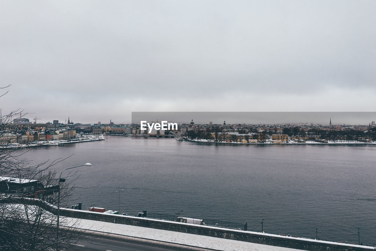 View of bridge over river against cloudy sky