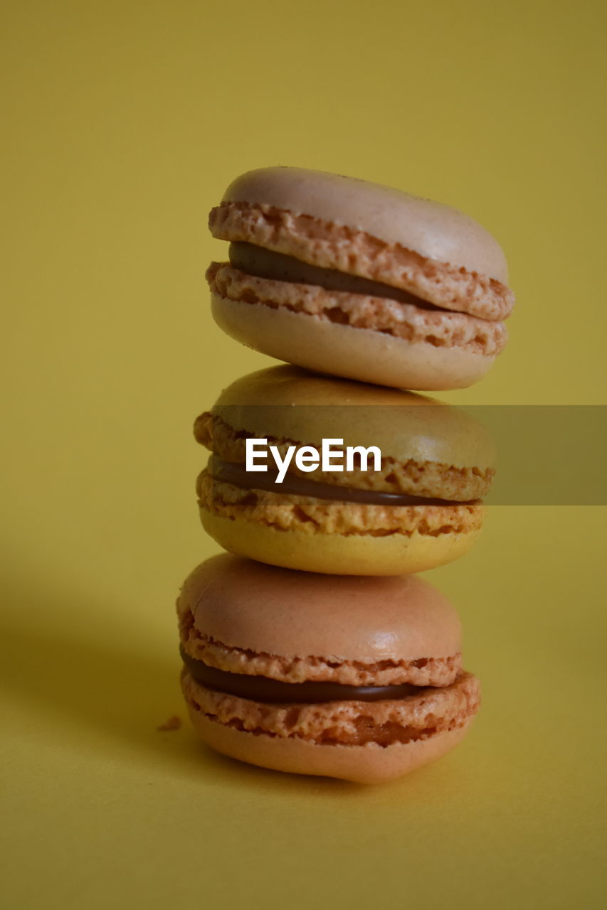 Close-up of macarons against yellow background