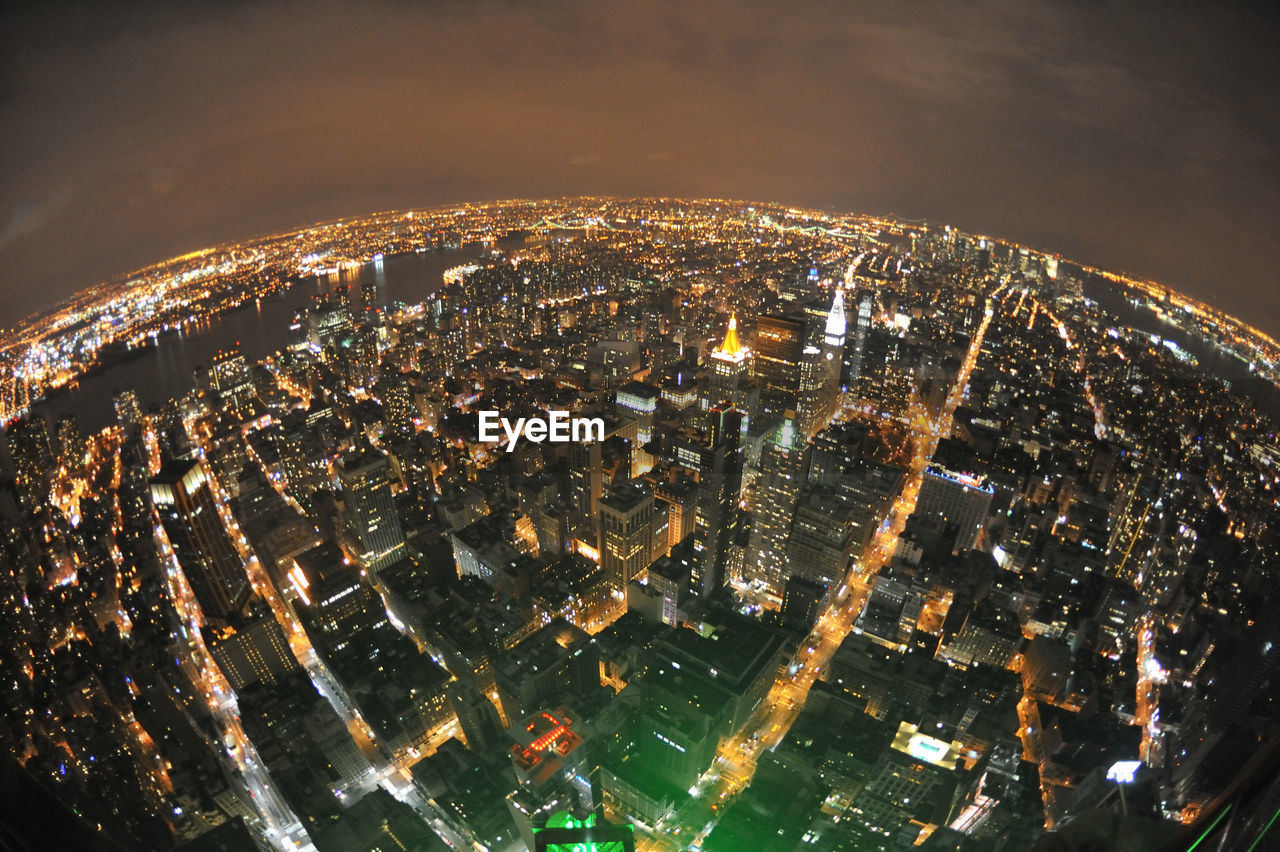 Aerial view of city lit up at night