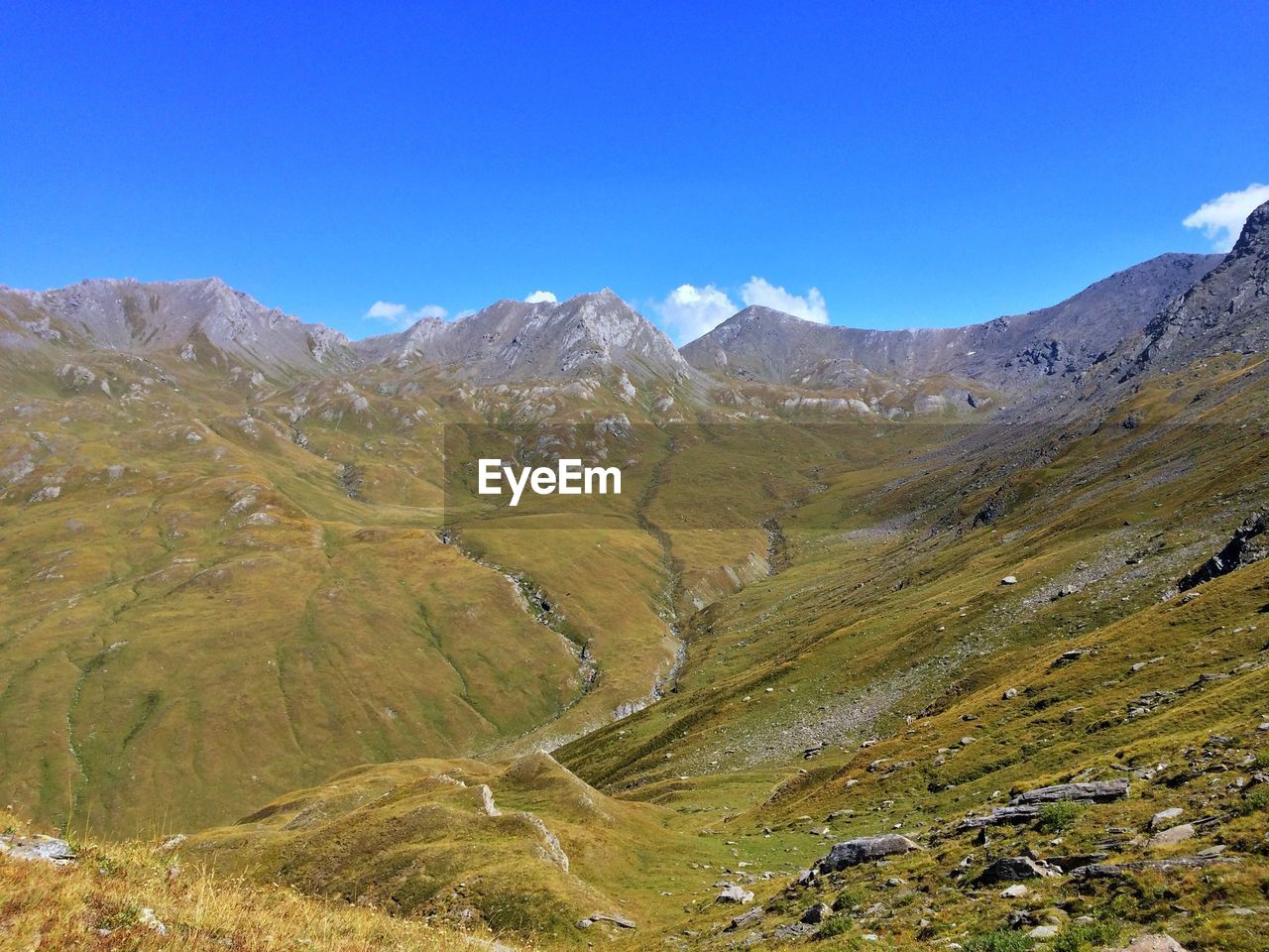 Scenic view of mountains against clear blue sky