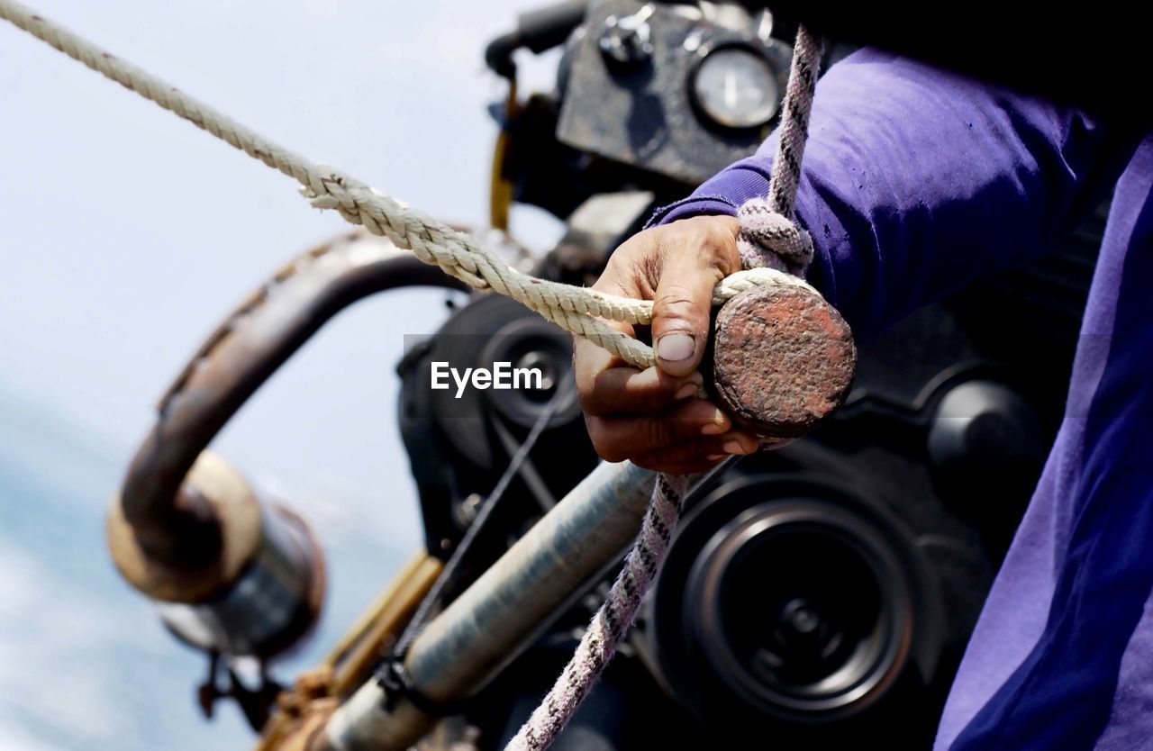 Close-up of man working on motorcycle