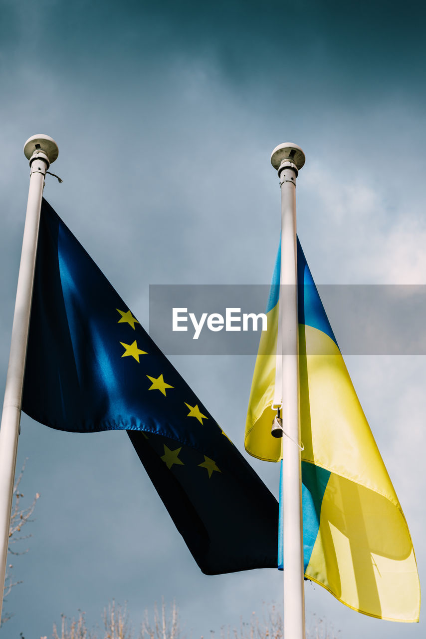 The flag of the european union and ukraine flutter in the wind