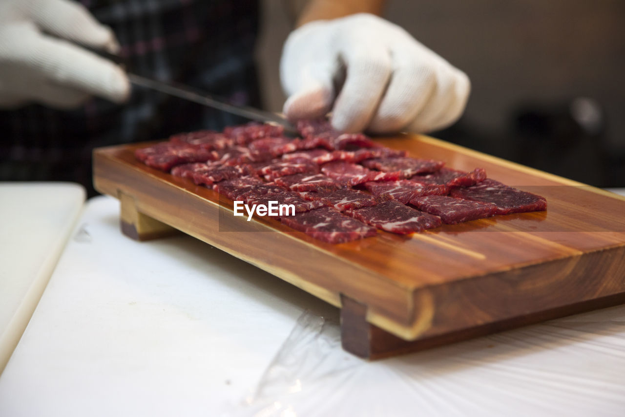 Close-up of chef preparing beef sashimi