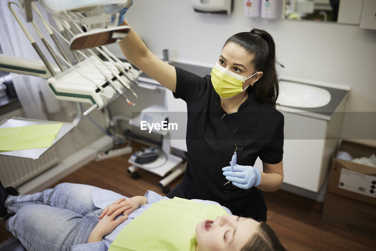 Female dentist with patient in office