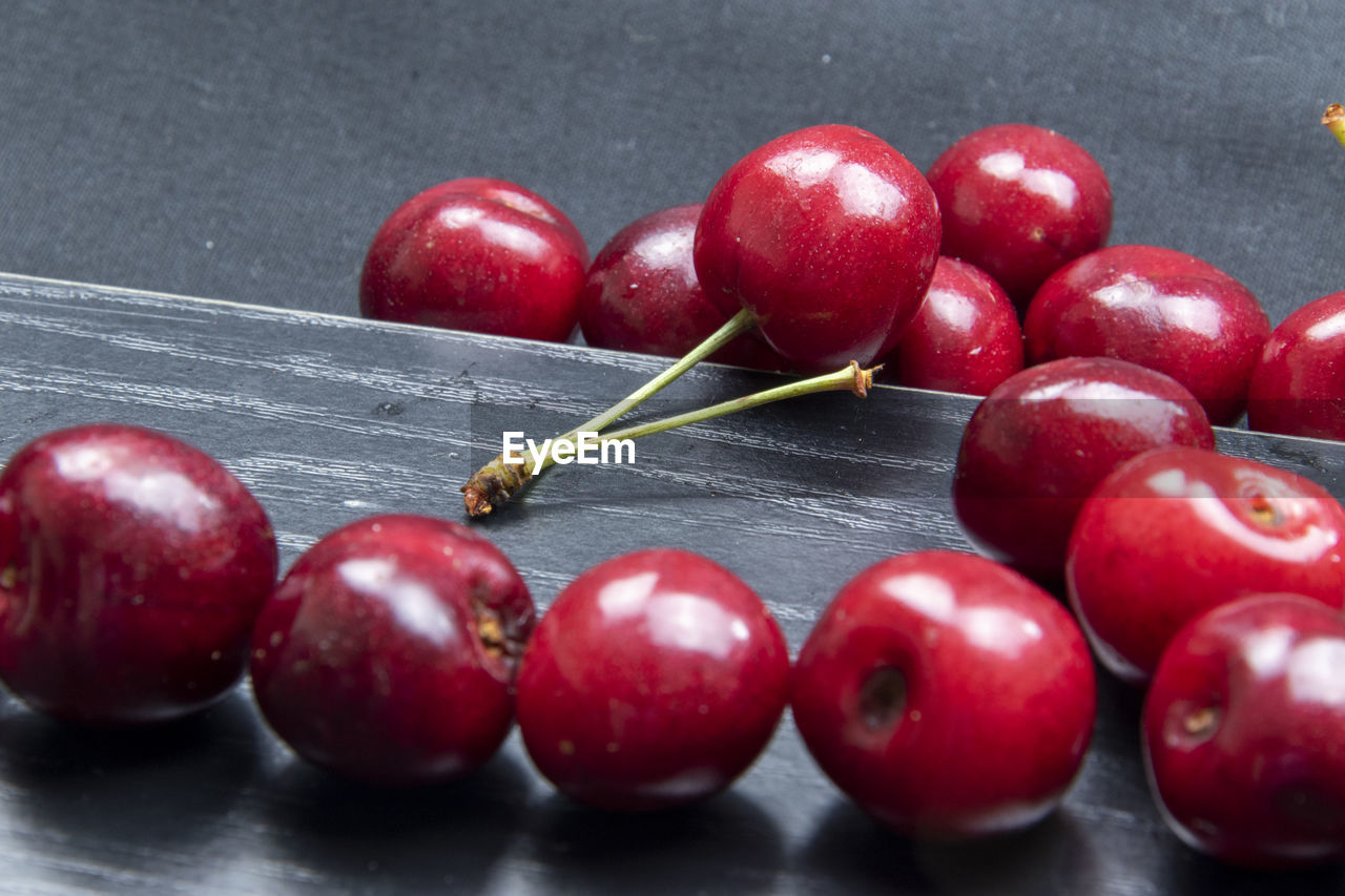 CLOSE-UP OF CHERRIES ON TABLE