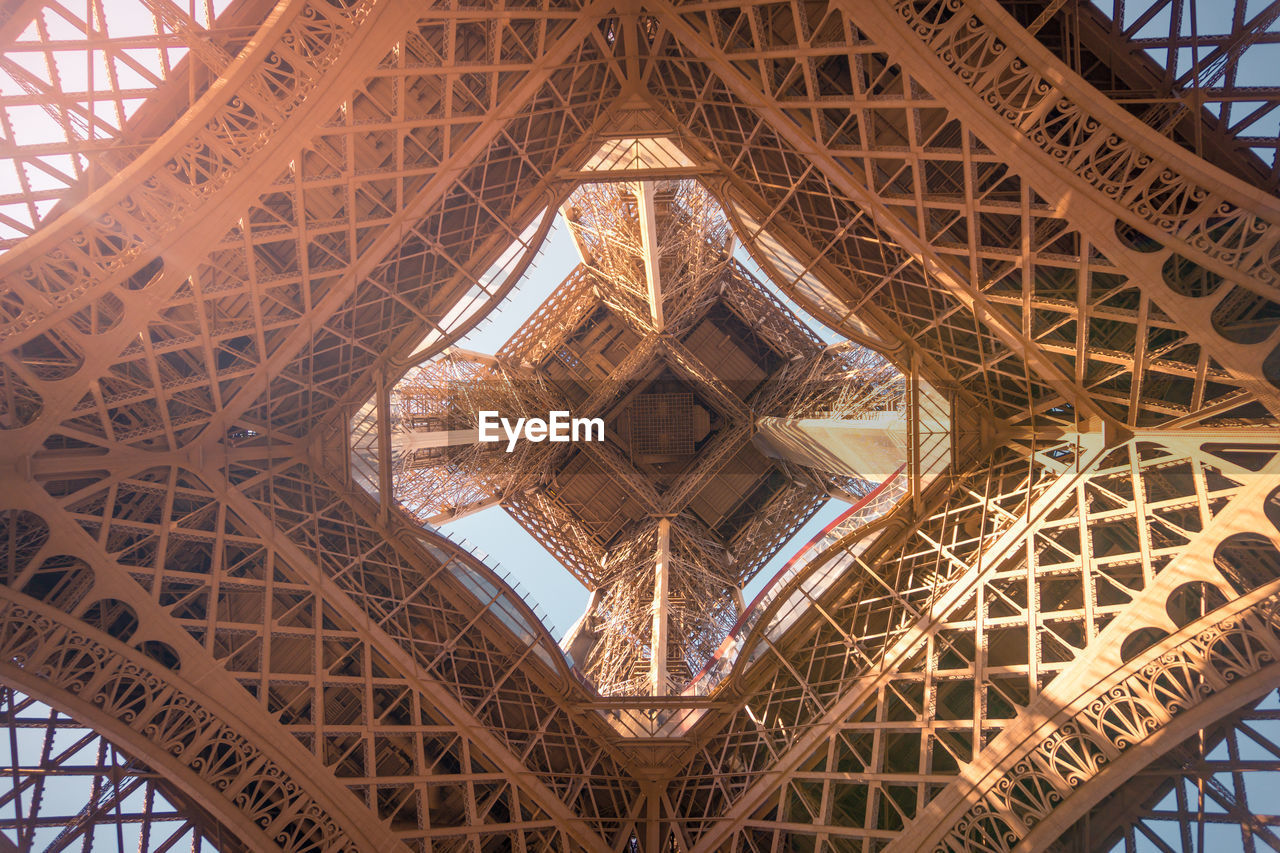 From below of observation tower with support posts and symmetrical decor on sunny day in paris france