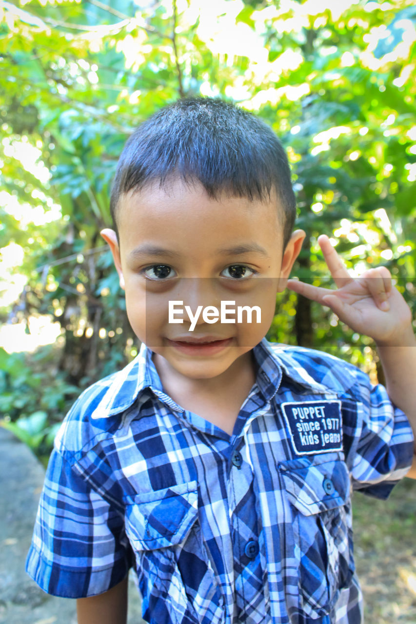 Portrait of smiling boy gesturing